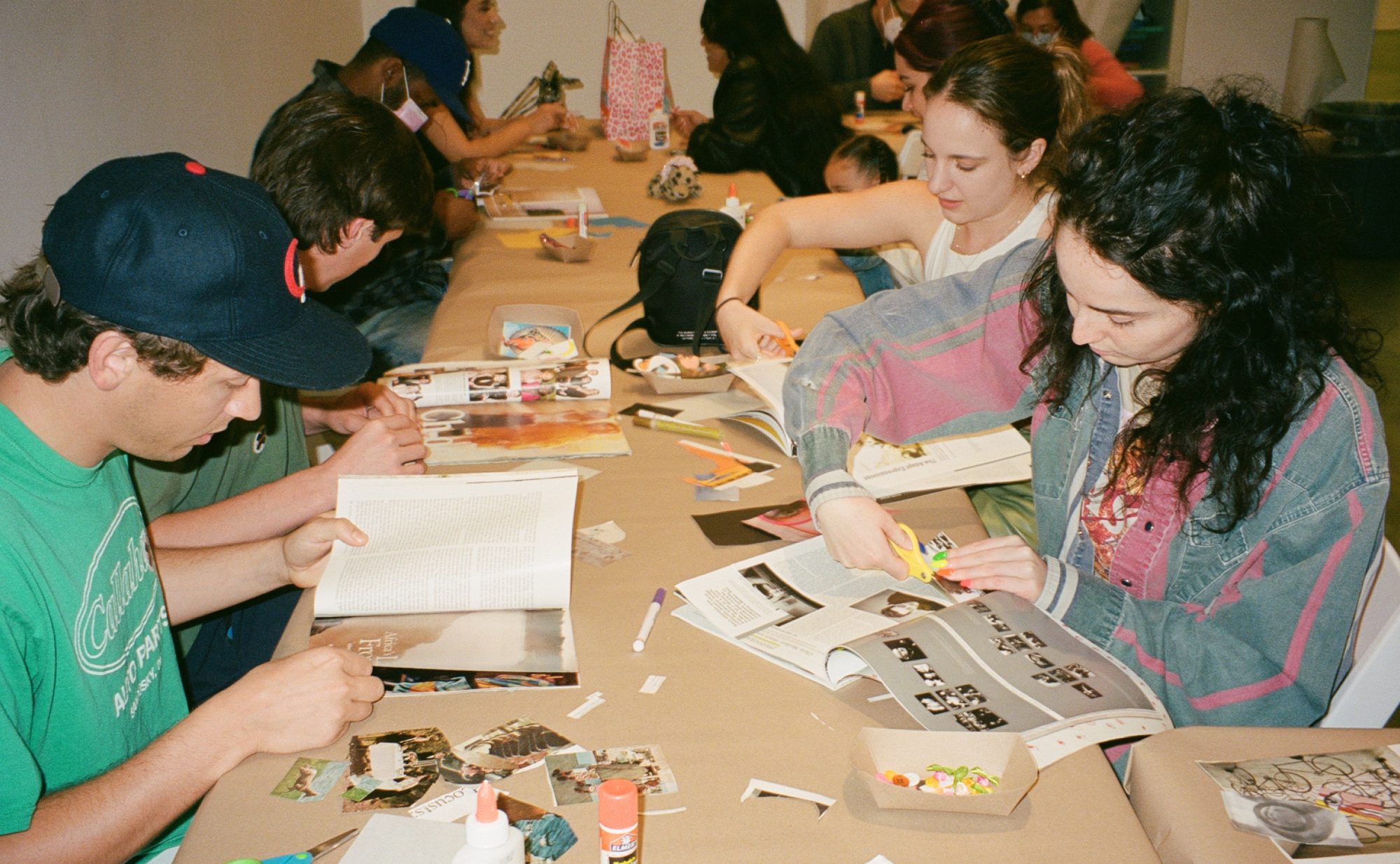 Group of Gen Z at table making collages