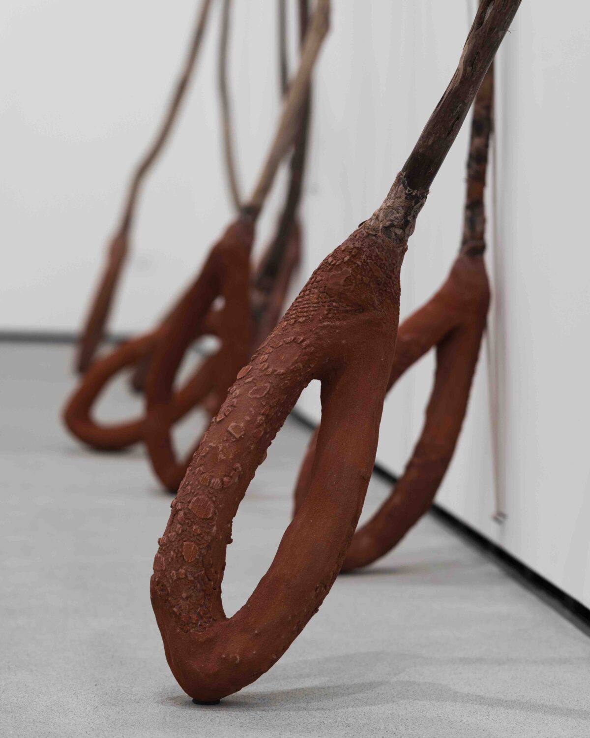 Close up of enlarged slingshot sculpture focusing on the end of the slingshot, which resembles a needle eye