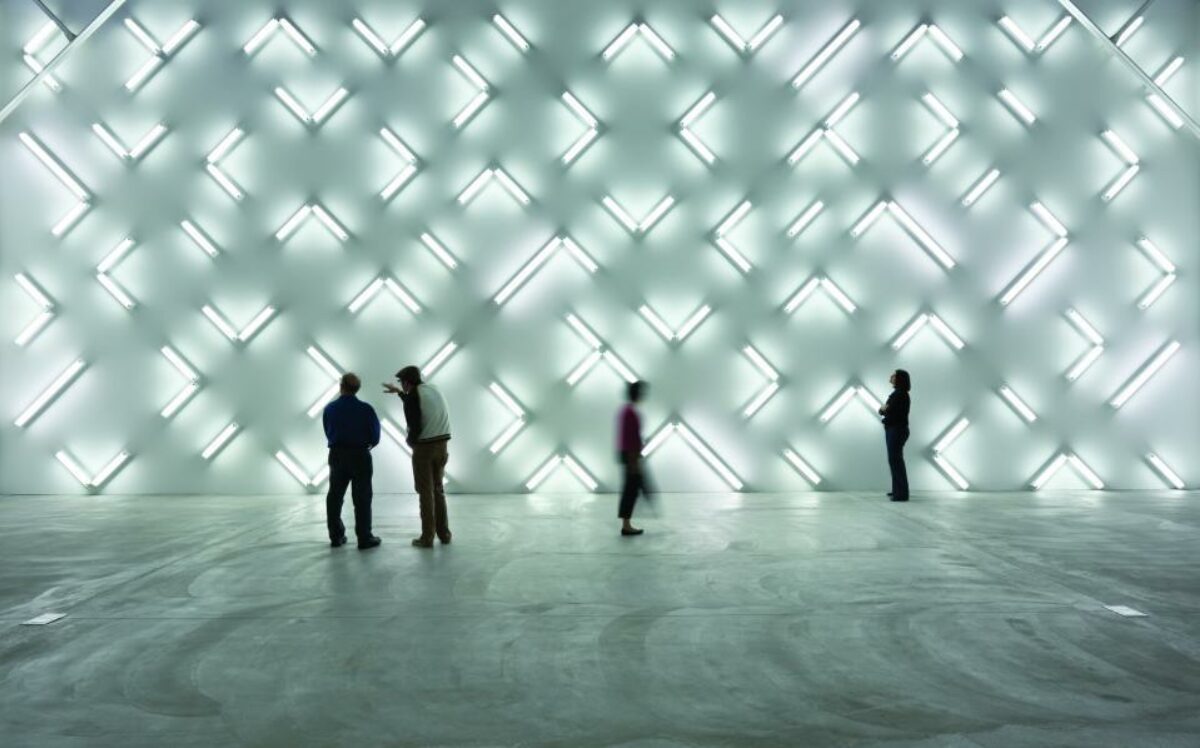Irwin Light Space. Viewers stand in empty space, absorbing bright lights that beam off the wall.