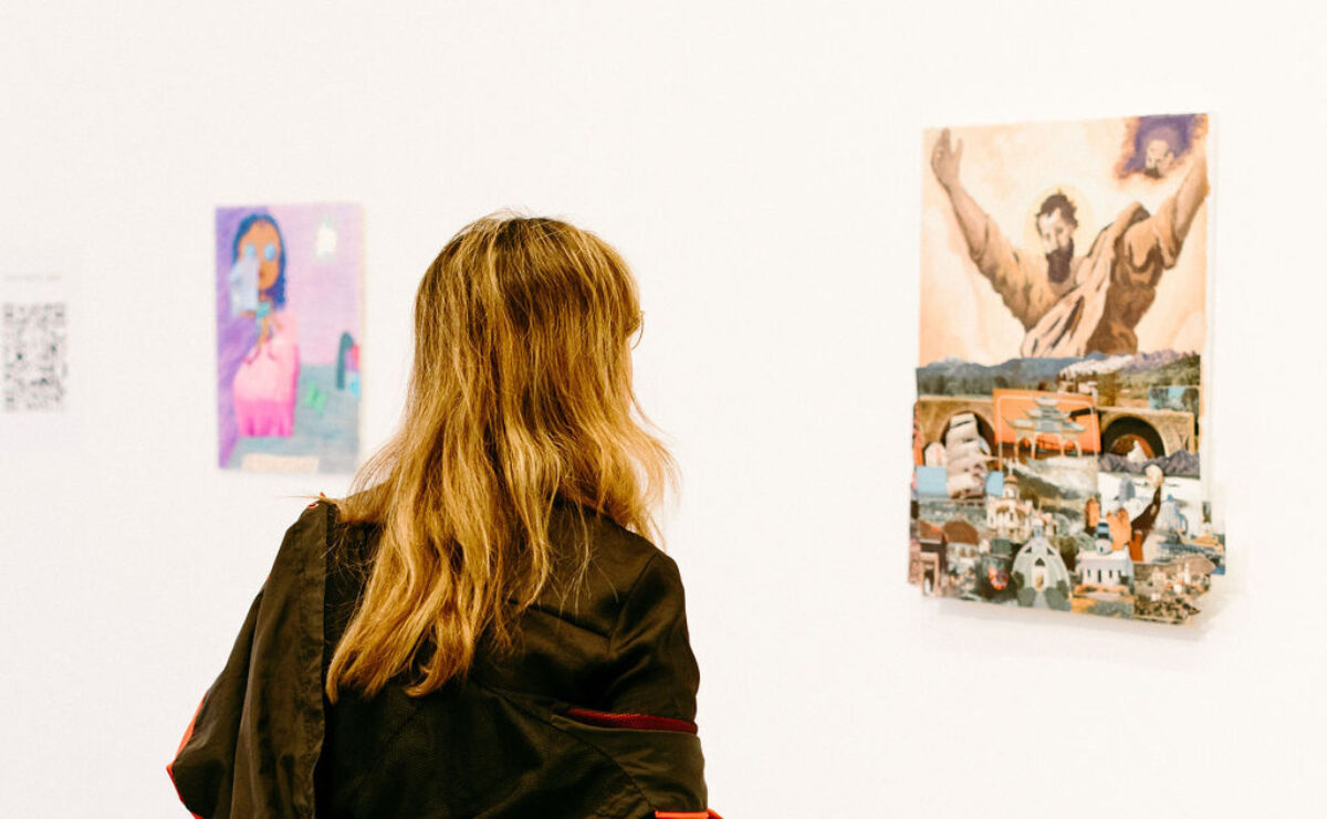 A youth looks at artwork.