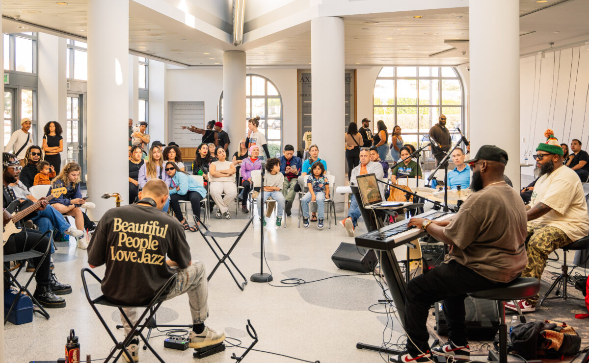 People in a circle listening to a jazz band.