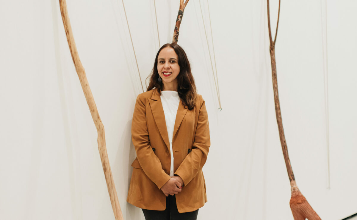 Griselda Rosas smiles in front of her slingshot-inspired installation piece