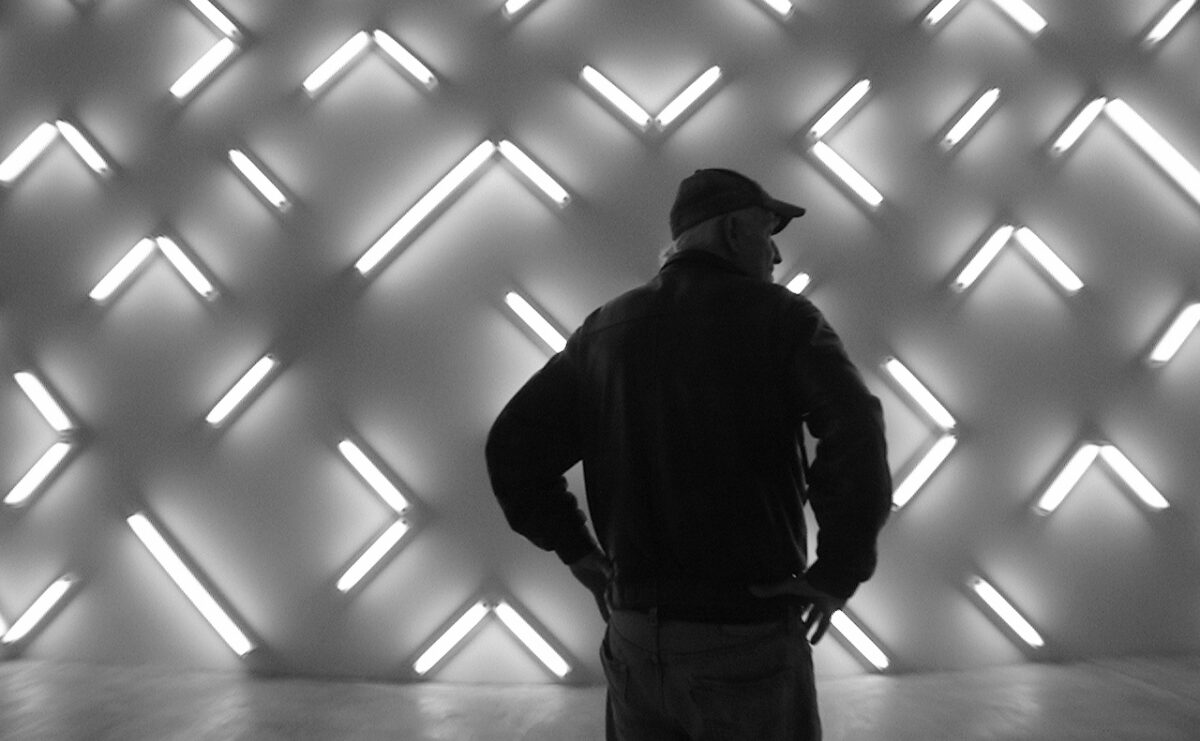 Black and white image of artist Robert Irwin in front of his installation