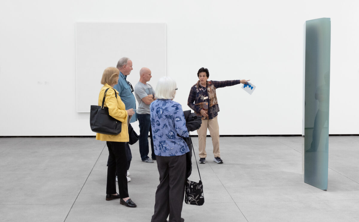Person leading a tour for four guests at MCASD