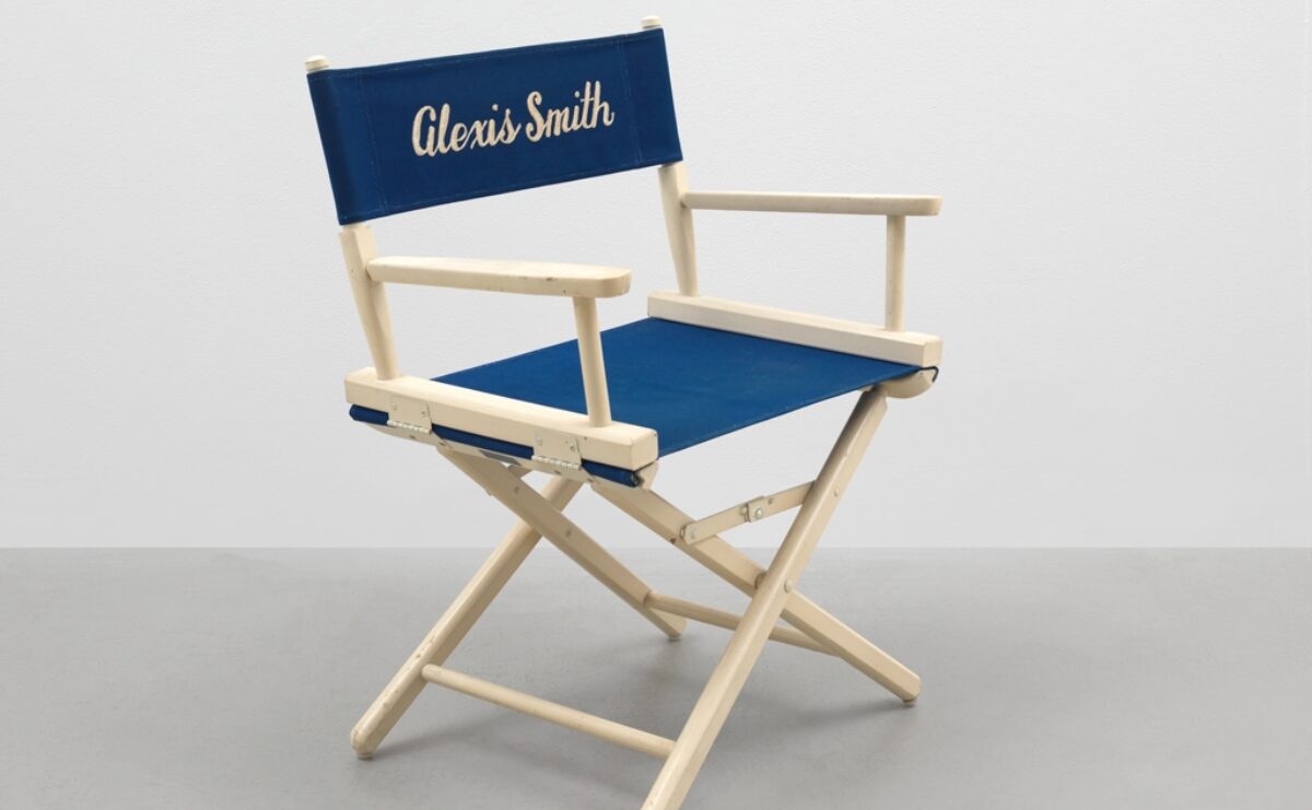 A directors chair with Alexis Smith printed on the blue fabric.