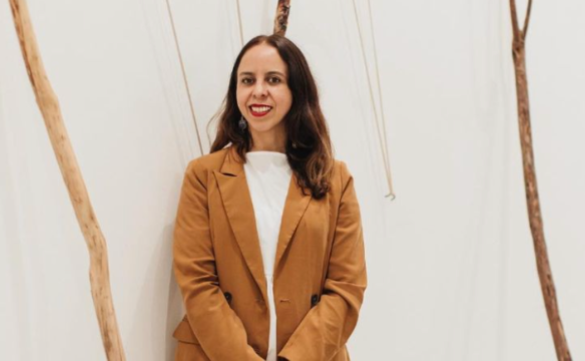 Griselda Rosas smiles in front of her slingshot-inspired installation piece
