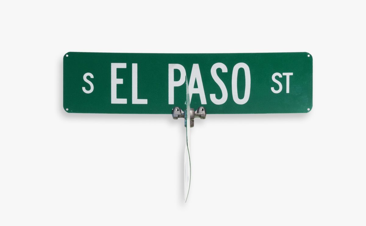 Green street sign that reads "EL PASO" in white