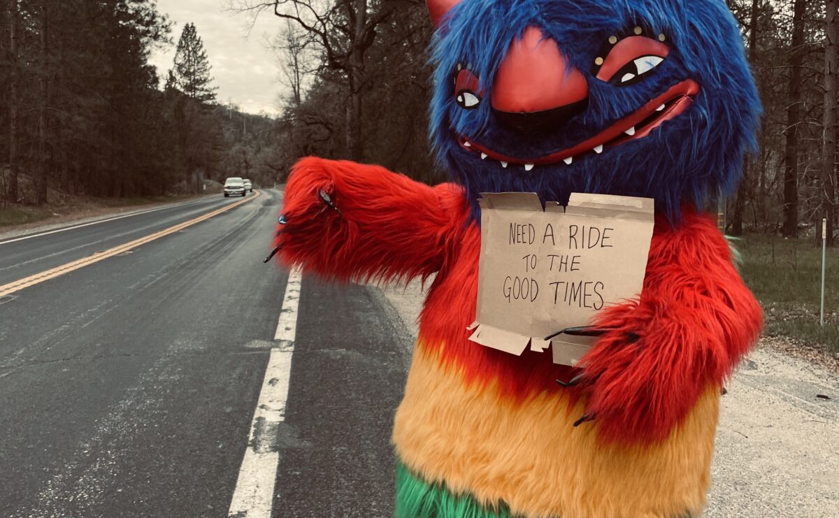 Image of life-sized puppet on the road catching a ride