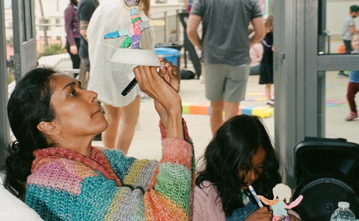 A parent and child make DIY sculptures.