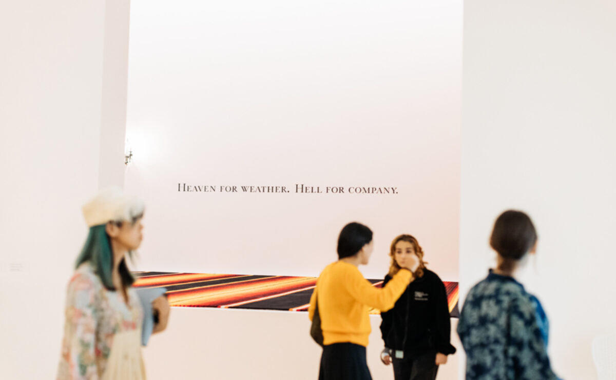 Four people walking through a gallery