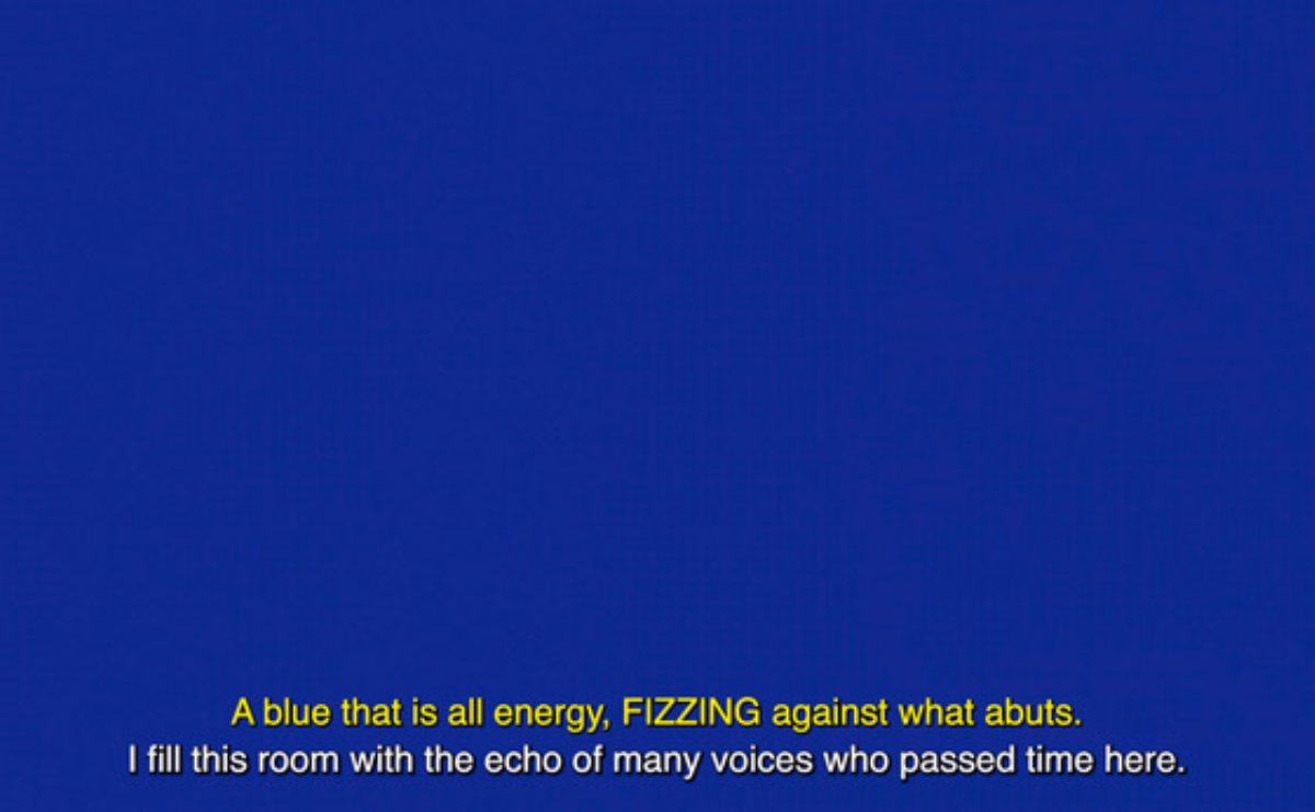 A blue screen. In yellow "A blue that is all energy, FIZZING against what abuts." In white "I fill this room with the echo of many voices who passed time here."