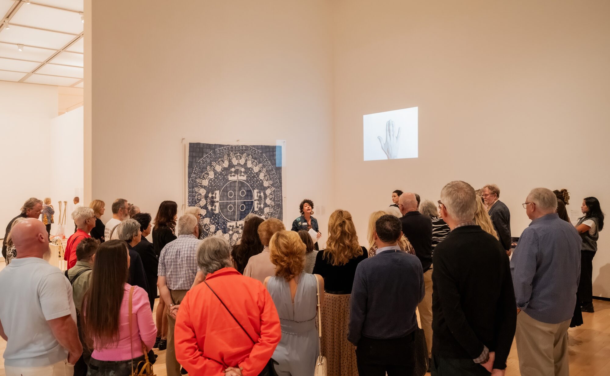 People on a tour of an art gallery.