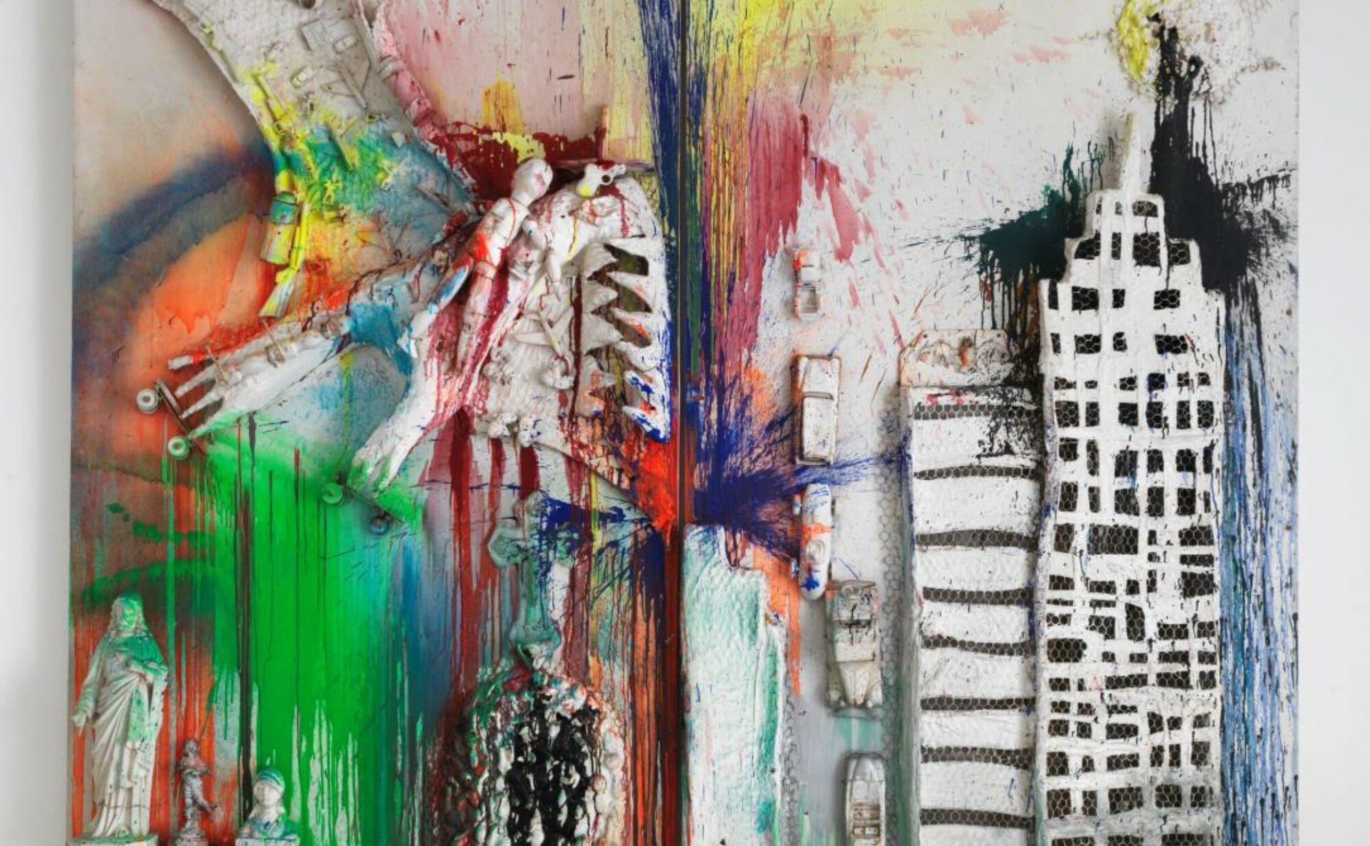 Splattered, saturated paint drips over a mock up of New York's cityscape by Niki de Saint Phalle