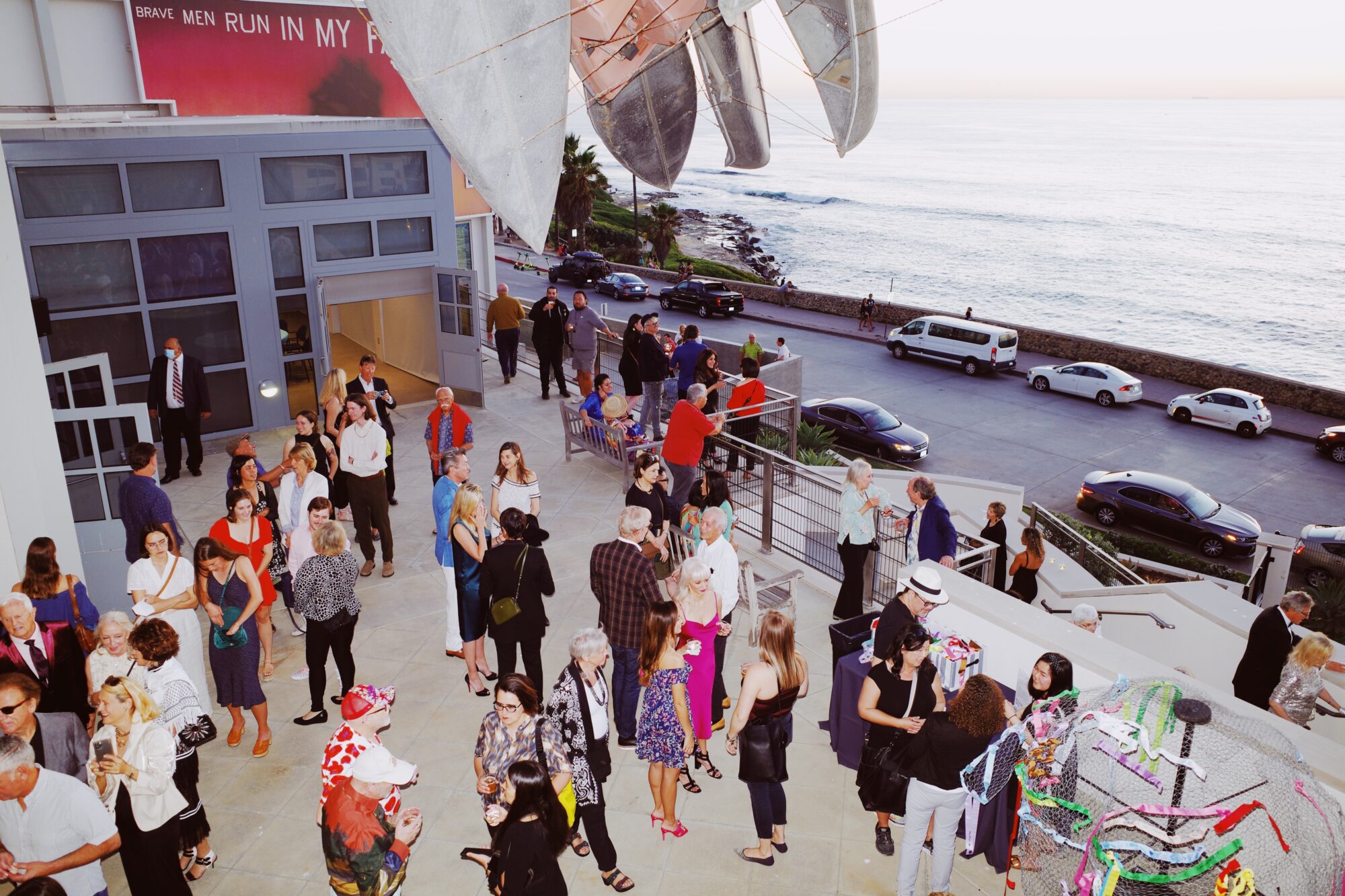 Birds-eye view of people on a terrace with ocean views