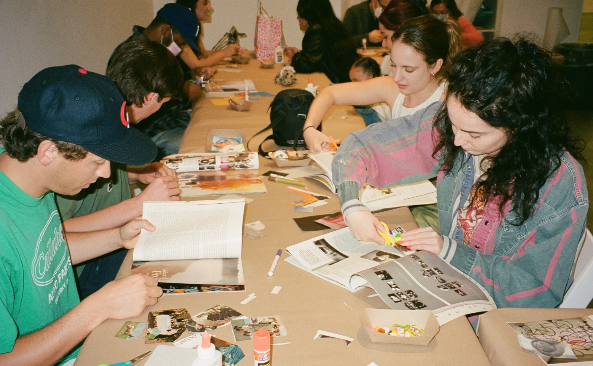 Group of Gen Z at table making collages