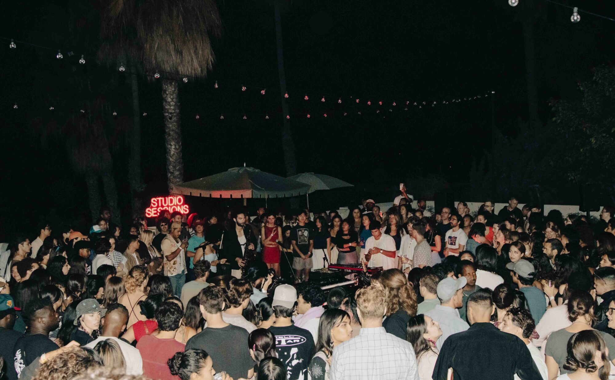 A crowd of people surround a jazz band in Art Park.