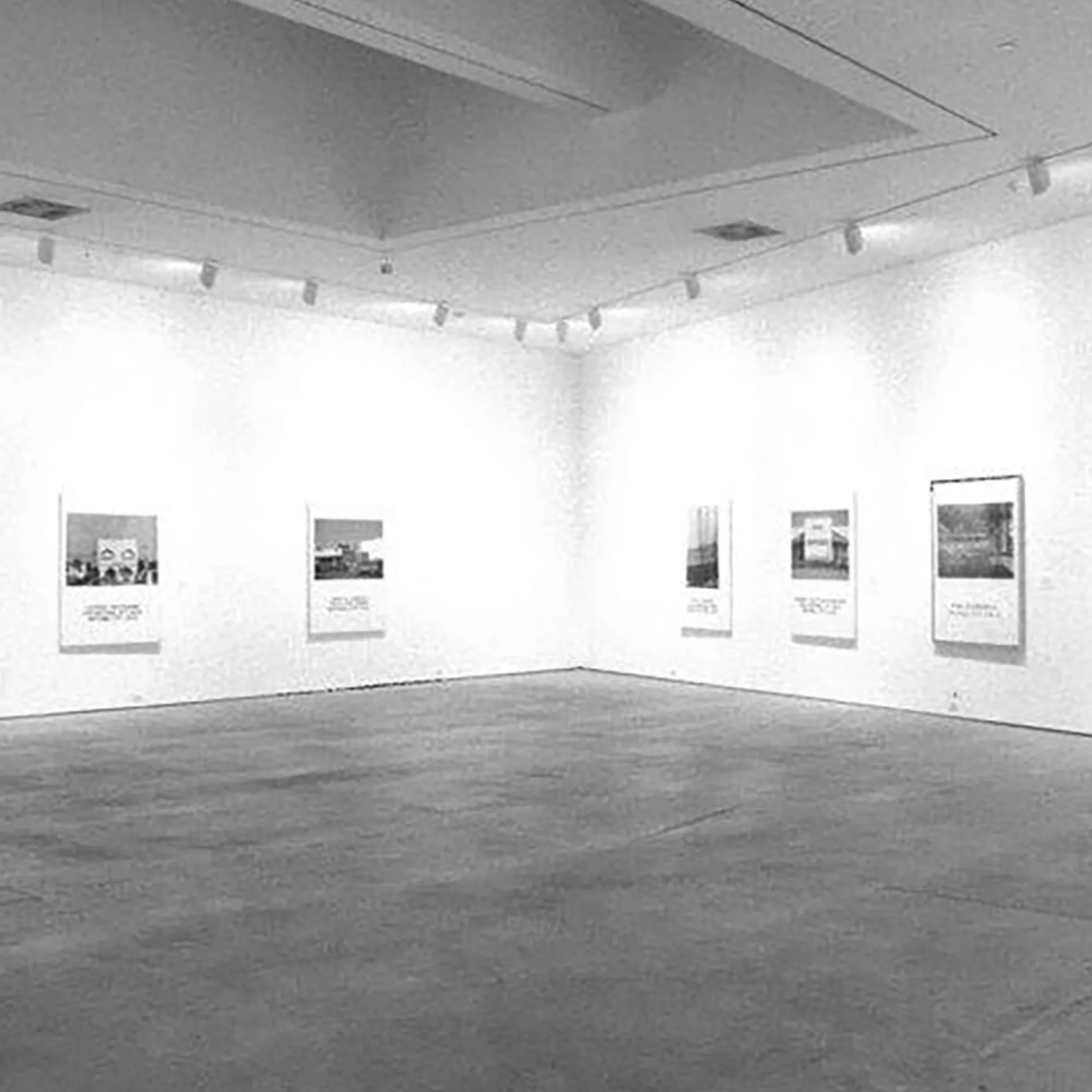 Prints by the artist John Baldessari, featuring typography and photography, are framed neatly inside this museum.